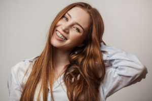 a patient with braces smiling